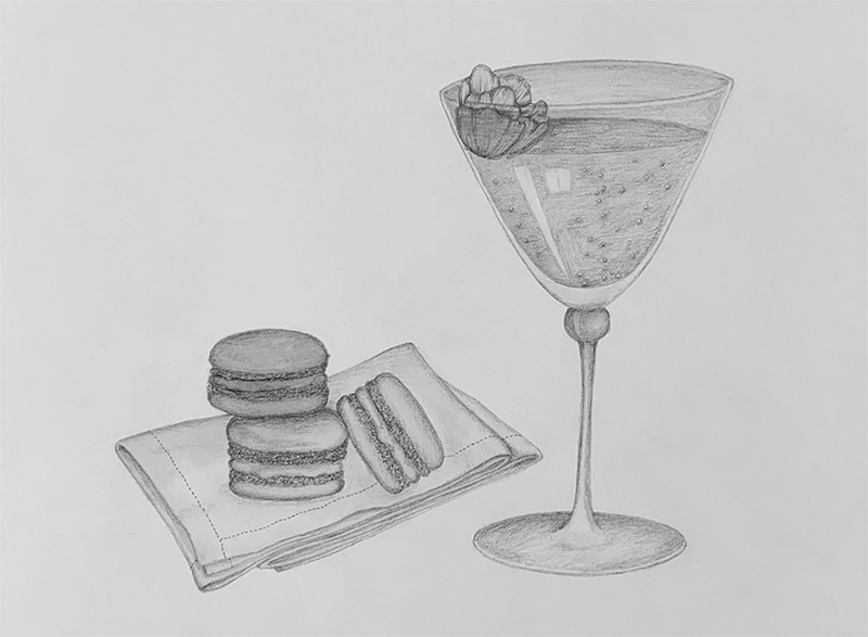 champagne og tre macarons serveret på en serviet til firmafest